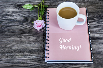 Notebook,Pink Rose and Cup of Coffee for Good Morning.Spring Morning Concept