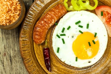 Fried egg for breakfast. Diet food. Food preparation. Fried egg on a wooden table.