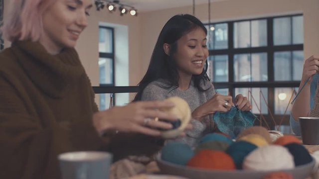 14. Smiling girls in a knitting lesson indoors