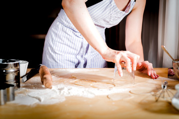 Fototapeta na wymiar Making dough by female hands