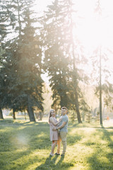 Beautiful young couple in the Park on a Sunny day, loving and happy. Walk and laugh. Pre-wedding shooting in nature. Casual style in clothing and European in processing