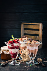 Assortment of chocolate berry desserts. On a wooden background. Top view. Copy space.