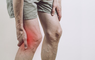 Pain under the knee of a man. Inflammatory process of the knee joint. Rupture of the meniscus.