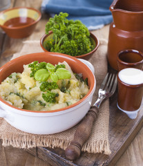 Mashed potatoes in a bowl on a wooden background. Copy space.