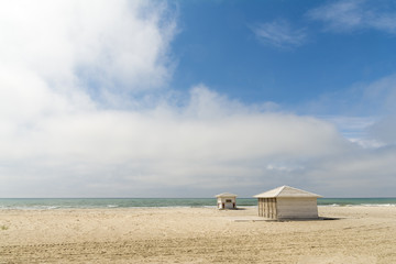 Fototapeta na wymiar Empty sandy beach with closed bars
