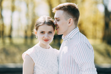 Beautiful young couple in the Park on a Sunny day, loving and happy. Walk and laugh together....