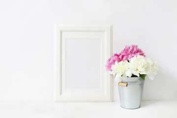 White blank wooden frame mockup. Wedding table still life composition with floral bouquet made of...