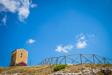 Sicily, Italy. Old house with purple flowers in Syracuse.