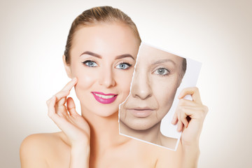 portrait of young woman face holding portrait with old wrinkled face