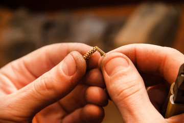Jeweler makes a piece of jewelry