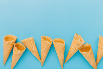 Empty waffle cones on blue background