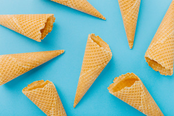 Empty waffle cones on blue background