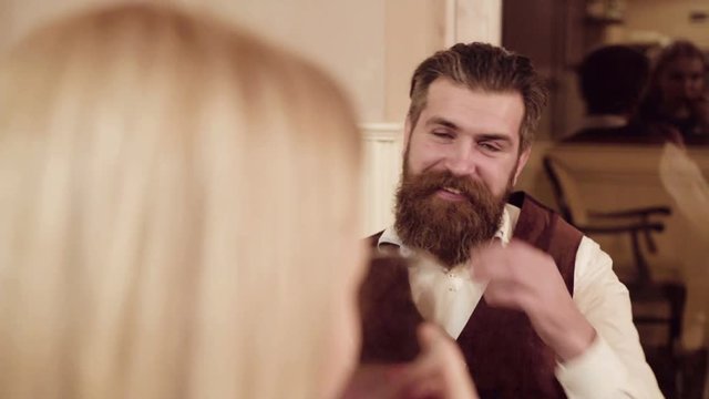 Couple in love. Handsome man flirting with cute woman in restaurant. Bearded man flirting with young sexy blonde