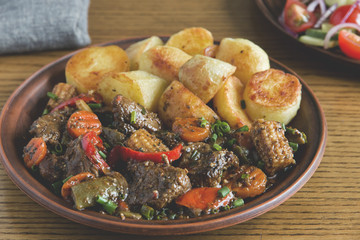 beef stew with vegetables and fried potatoes