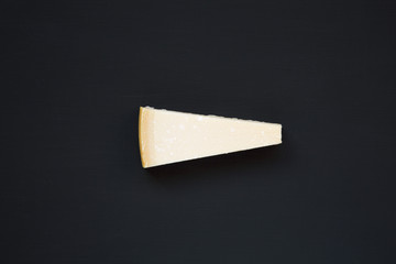 Parmesan cheese on dark background, top view. From above.