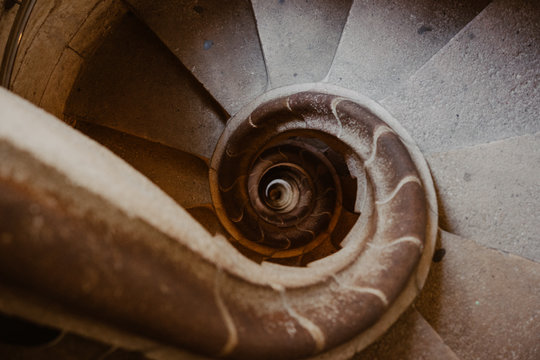 Top shot of spiral stone stairs leading down as abstract background