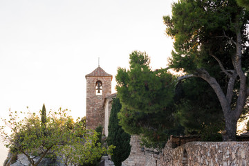 Fototapeta na wymiar View of the Romanesque church of Santa Maria de Siurana at sunset in Siurana de Prades, Tarragona, Spain. Copy space for text.