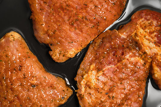 Cooking meat pieces in a frying pan
