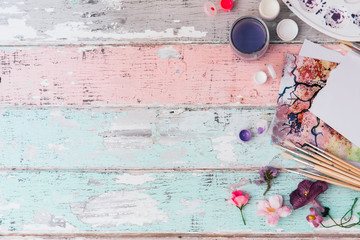 Flat lay art workspace on wooden background, artistic concept