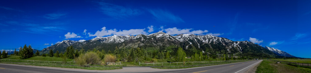 Beautiful panoramic view of Grand Tetons mountains partial covered with snow in the horizont during...