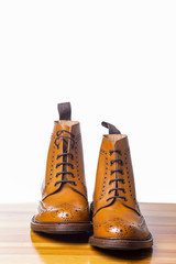 Footwear Concepts.Pair of High Gentleman Tanned Brogues Boots. Isolated Over White Background.