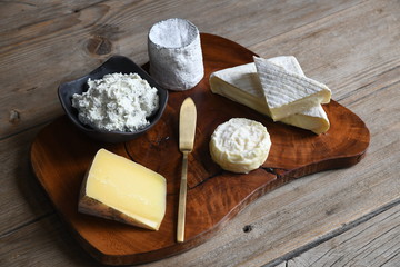Cheese wedges on wooden cutting board