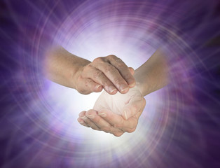Vortex spiralling between hands - female cupped hands with white vortex energy between on a purple...