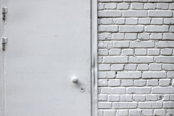 White brick wall. Metal door.