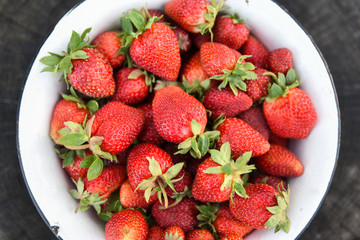 Retro bowl of fresh strawberries, top view, closeup. Stories about rural life in Ukraine