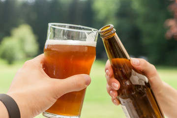 cheers glass and bottle of beer