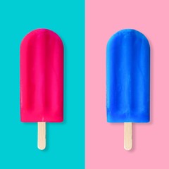 Pink and blue summer popsicles on a pastel blue and pink background. Minimal summer concept.