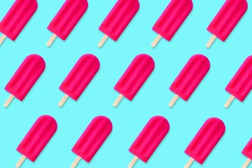 Colorful summer pattern. Bold pink popsicles on a pastel blue background. Top view.