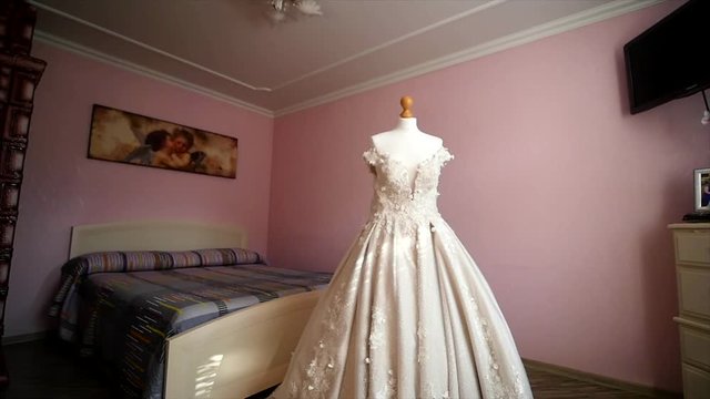 White wedding dress on a mannequin in the room