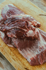 Delicious raw thick skirt steak, in the wooden board