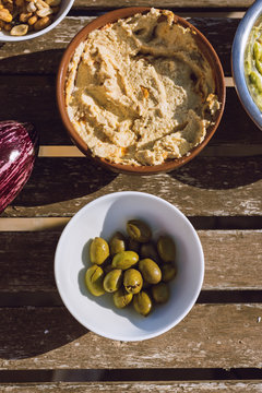 Hummus and green olives on the table, above.