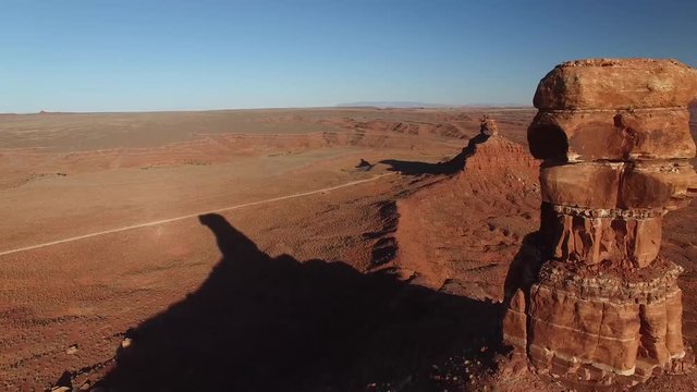 Aerial drone footage of butte and sandstone monument in Utah (backward view 2 of 3)