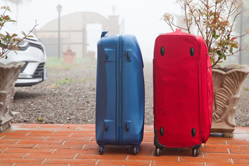  suitcases in front of house ready to go on vacation