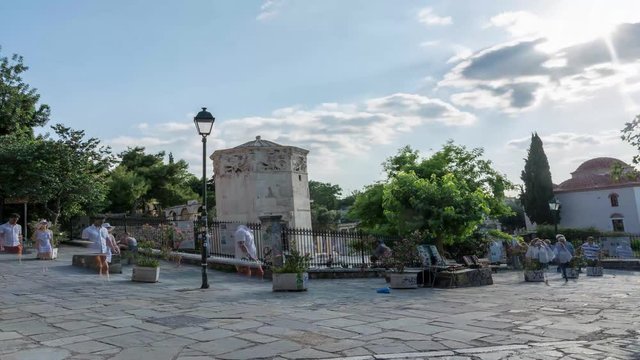  tourists walking around tower of the winds, athens, greece