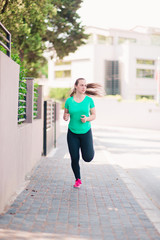 Modern young sports woman stretching leg muscles