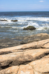 Waves hit the rocks on a beach in Itanhaem