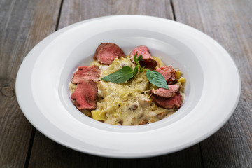 Pasta Fettuccine with veal and bechamel sauce. Modern Italian cuisine, deluxe restaurant menu, chef's recipe concept