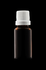 Herbal medicine or aromatherapy dropper bottle isolated on black background