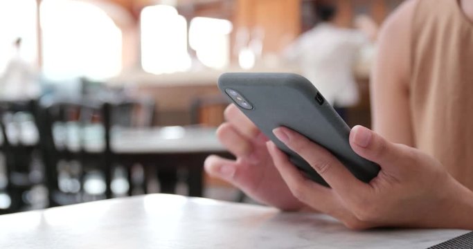 Woman use of smart phone in cafe