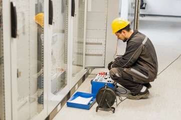Maintenance engineer inspect system with relay test set equipment