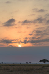 Fototapeta na wymiar Sunset in dark clouds. Amboseli, Kenya