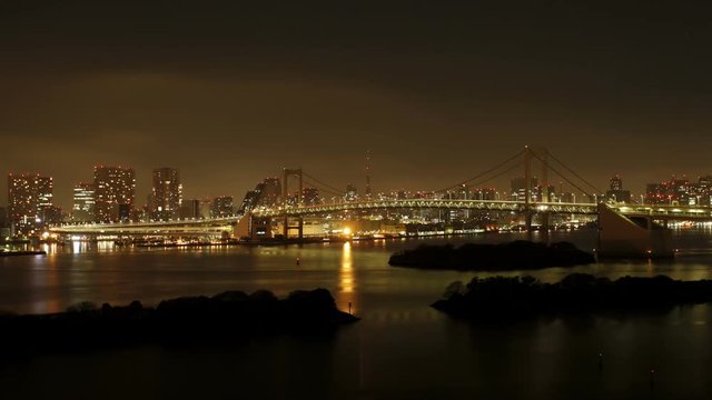 Day to night transition, Tokyo Tower and Rainbow Bridge at night, viewed from Odaiba artificial Island, Tokyo, Honshu, Japan