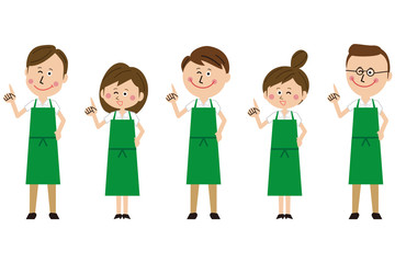 ポップな緑のエプロンをした男女のグループが指差し