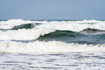 Waves breaking on the Caribbean Sea with blue sky in the background, as a nature background
