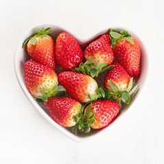 Fresh strawberry in heart shape bowl