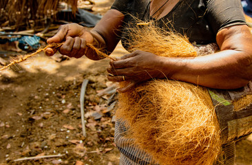 Women spin coconut hair by hand, turning it into a strong rope